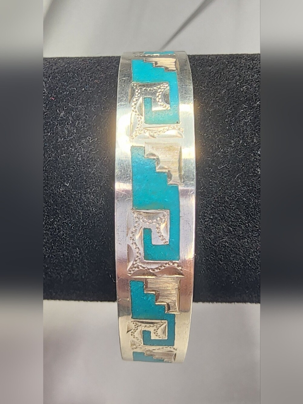Vintage Taxco bangle features intricate sterling silver work inlaid Turquoise